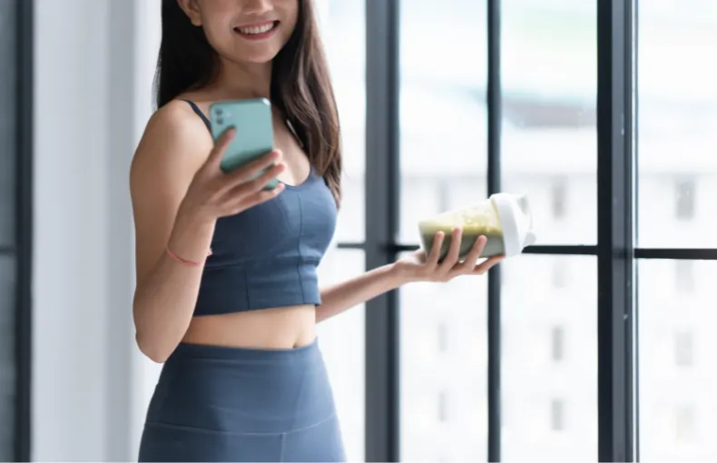 ブル―マリンスポーツクラブ小諸店のスマートフォンとサプメントを持つ女性